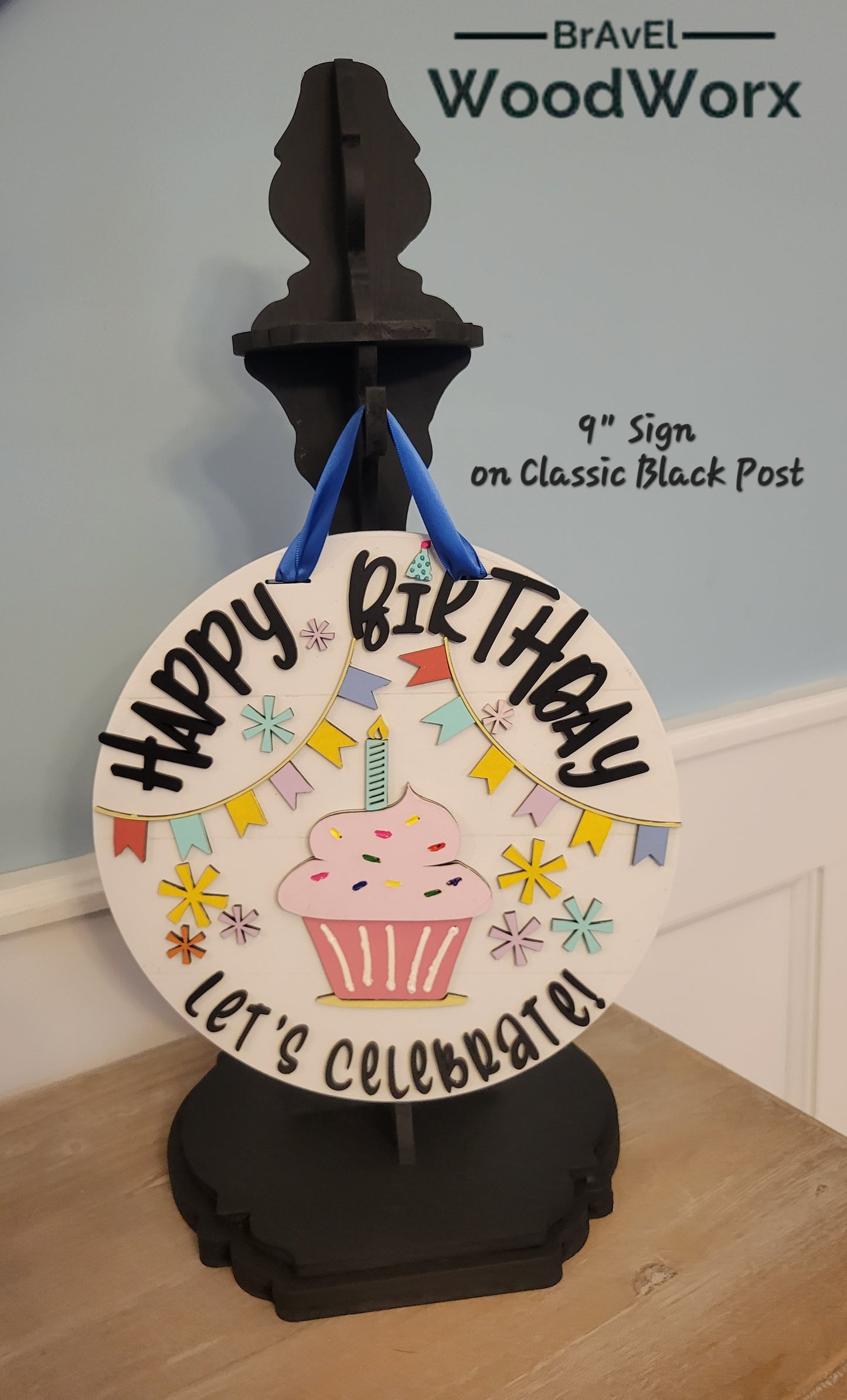 An image showcasing the 'Birthday Bliss: Festive Shelf Post Stand,' a decorative piece for home celebrations. The stand features vibrant, colorful details with interchangeable festive elements, ideal for seasonal birthday decor on shelves or tabletops. Black