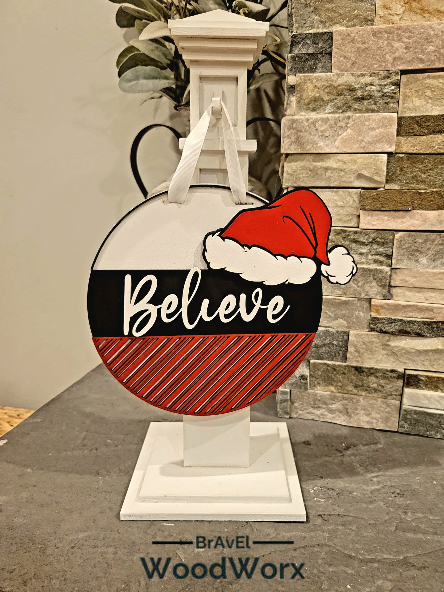 Festive holiday sign with layered lettering and Santa hat design, available in 15", 12", and 9" round sizes