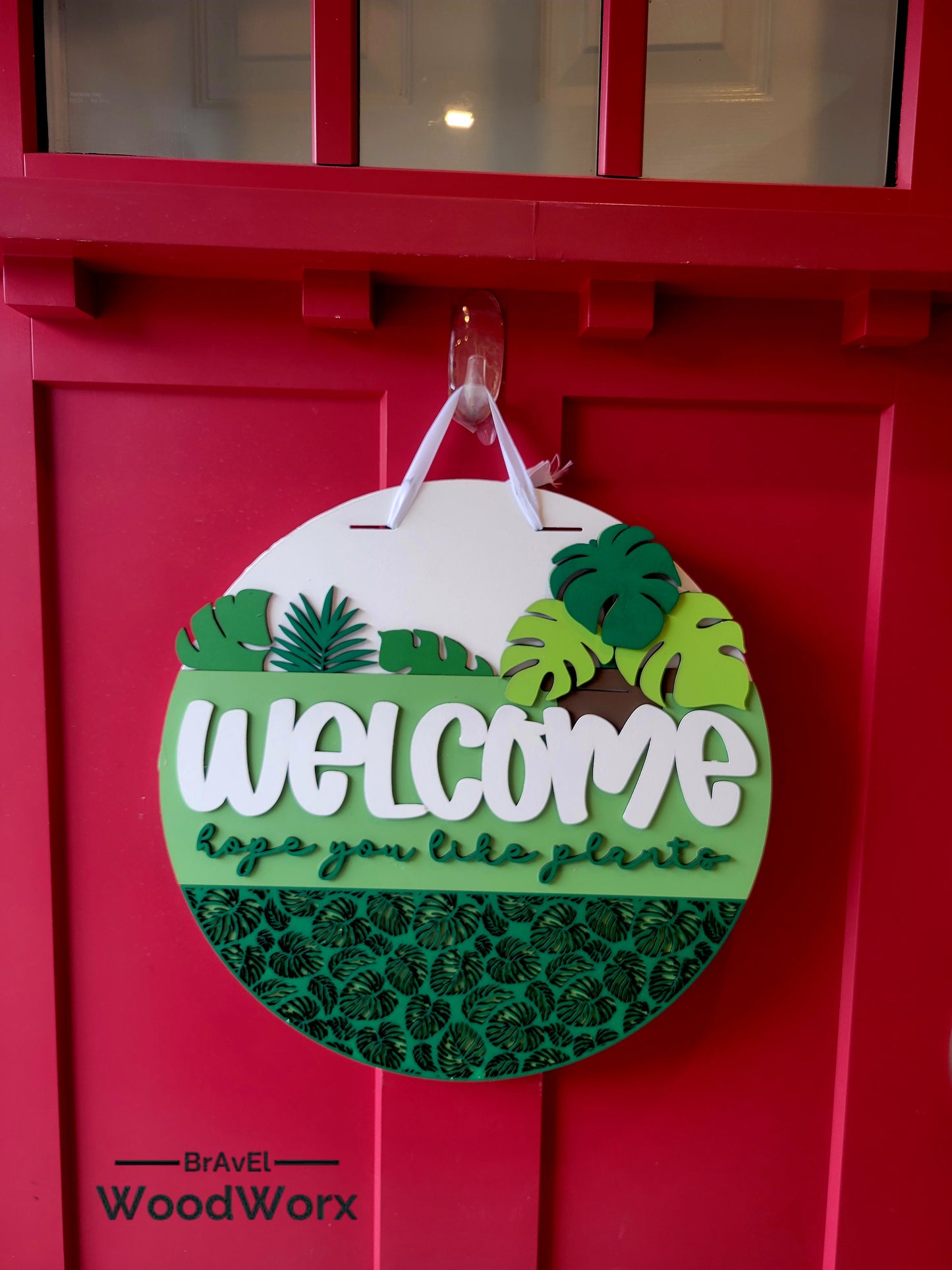 Welcome Plant Lovers decorative door sign with dimensional tropical foliage design