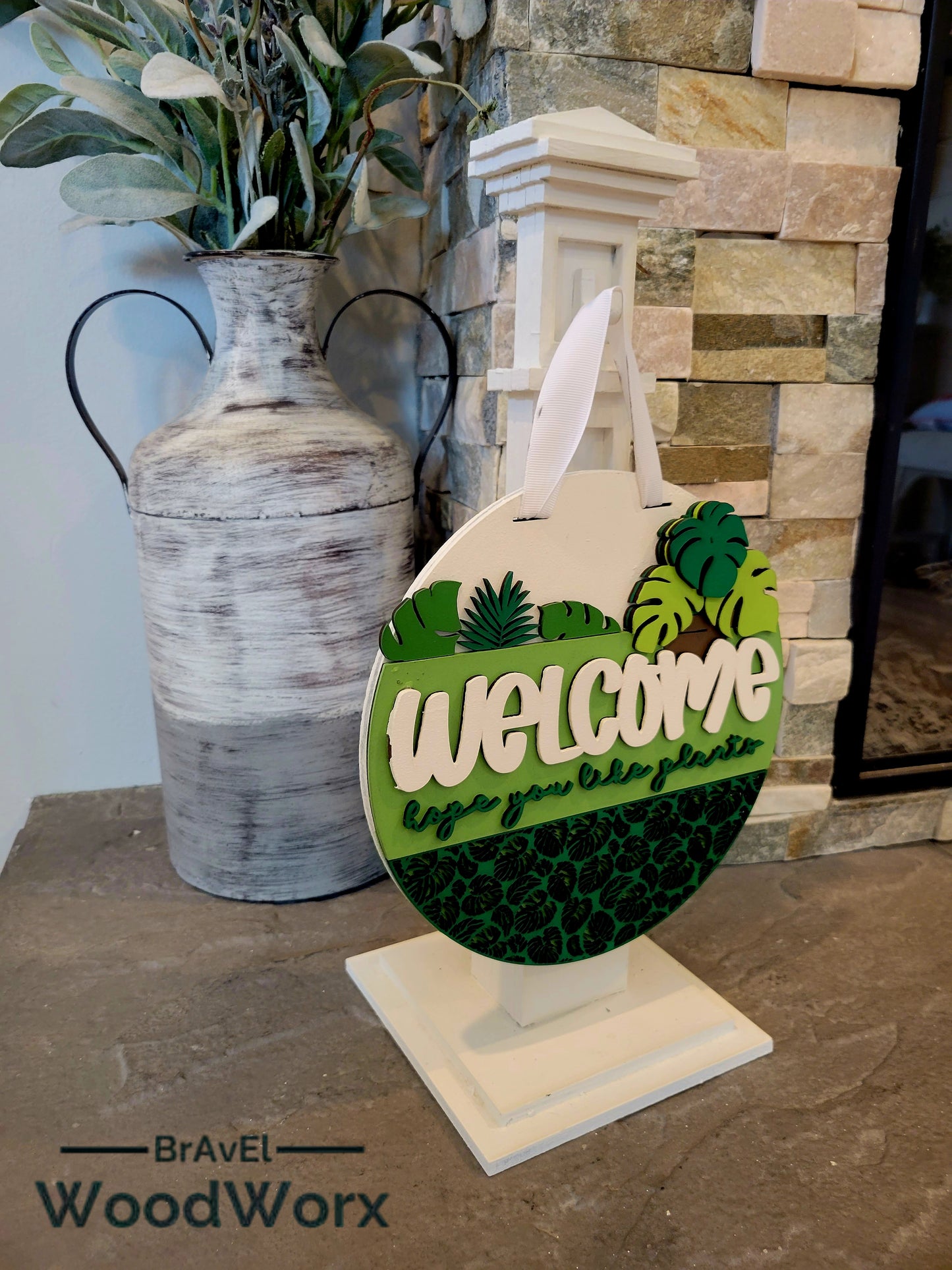 Welcome Plant Lovers wooden door hanger featuring 3D laser cut tropical foliage pattern