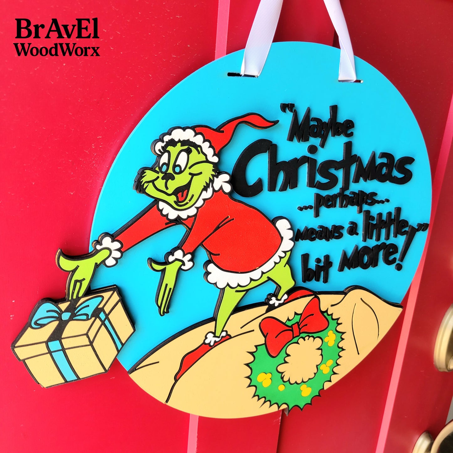 Decorative Christmas ornament with cartoon character and text on a red background, featuring BrAvEl WoodWorx branding.