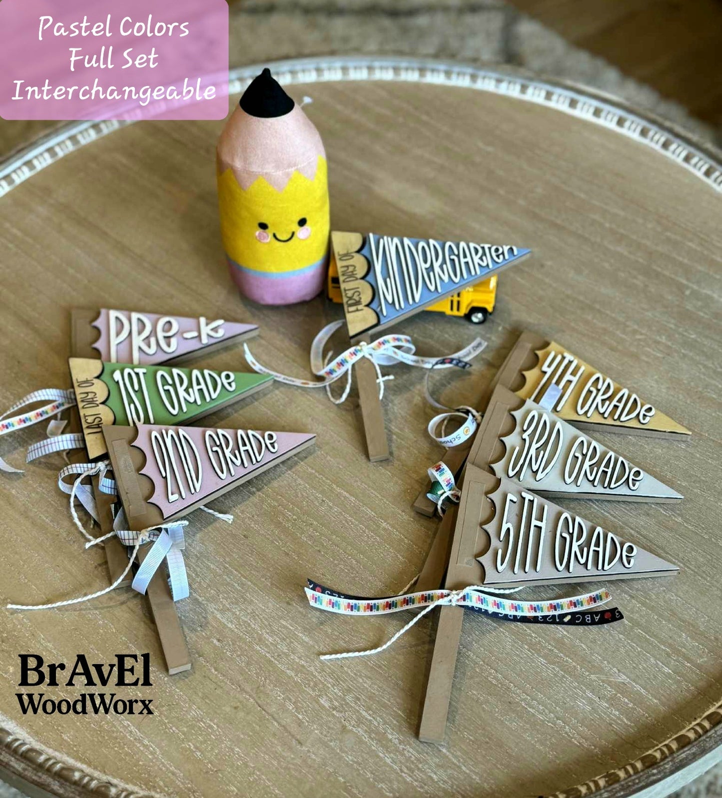 Set of educational-themed wooden flags with a pencil-shaped container on a wooden surface, featuring the brand 'BrAvEl WoodWorx'.