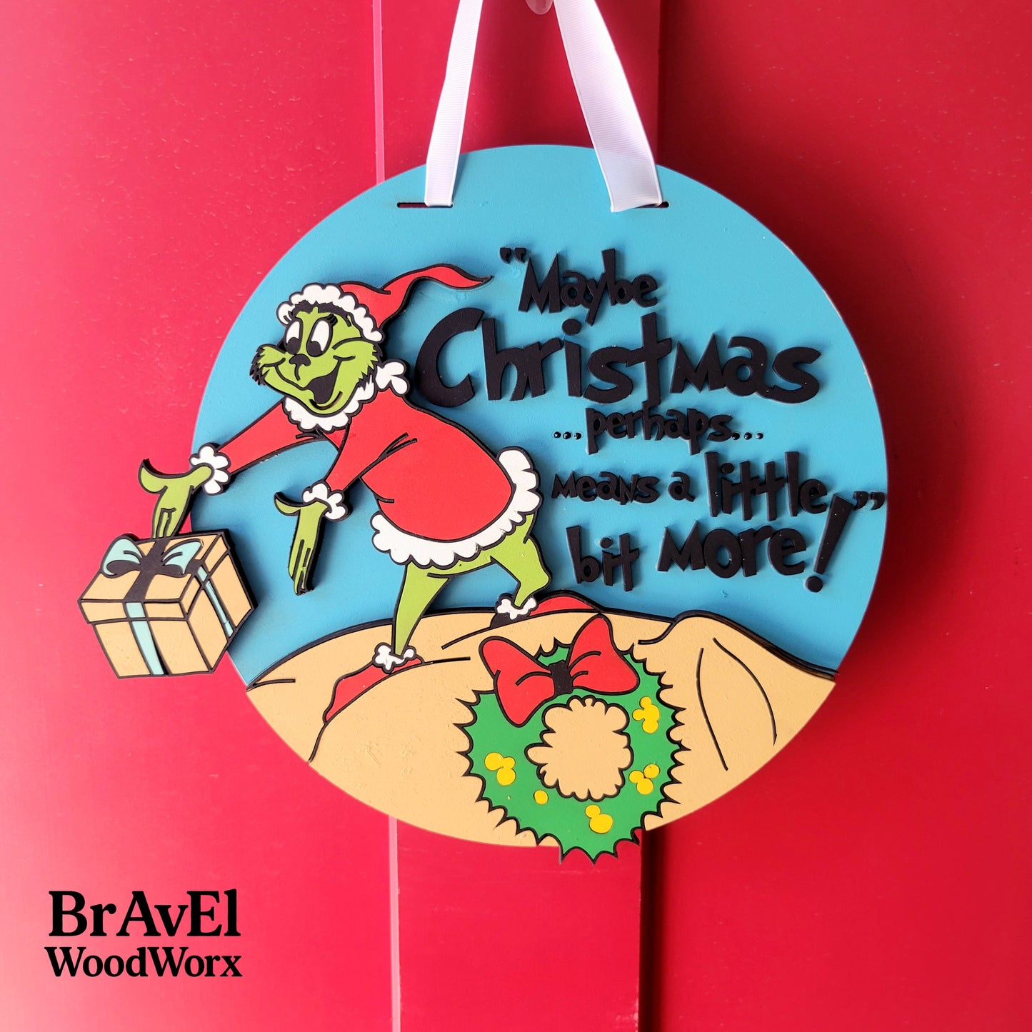 Decorative Christmas ornament with Grinch design and text on a red background, featuring the brand 'BravEl WoodWorx'.