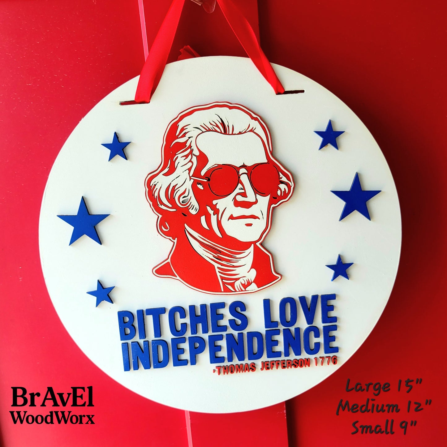 Decorative sign with a red portrait and 'Bitches Love Independence' text on a red background, featuring stars.