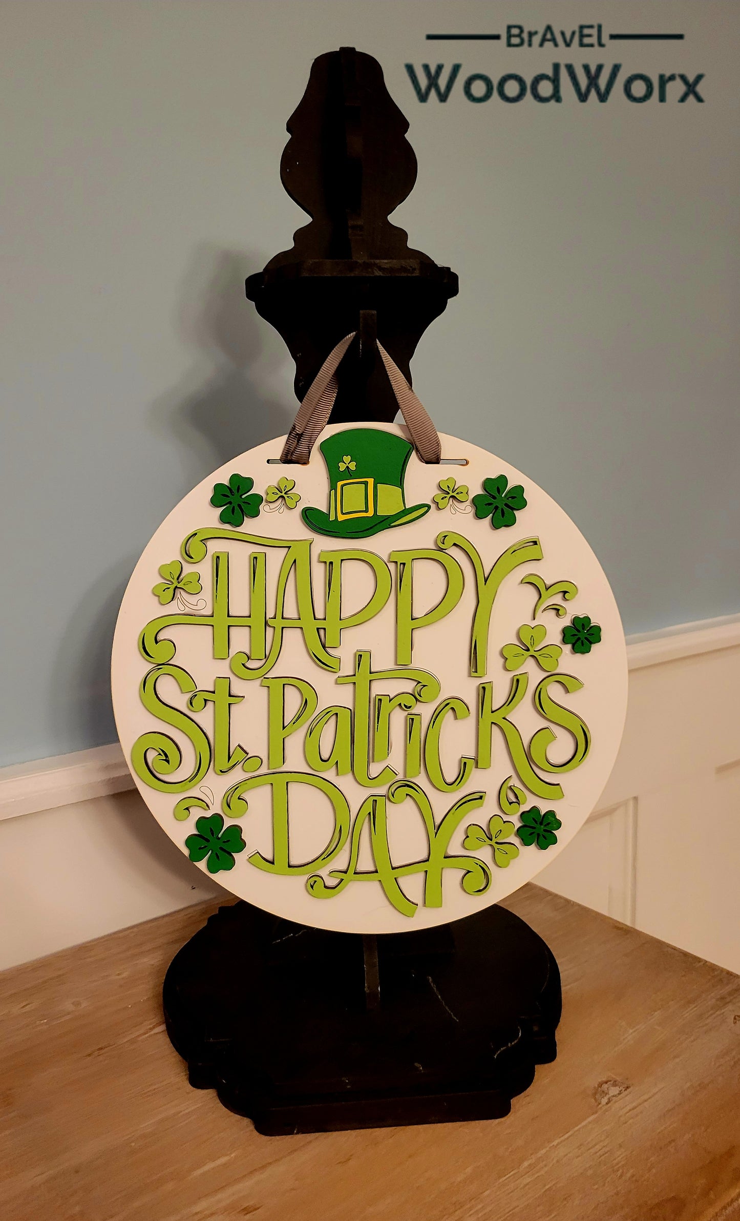 Festive St. Patrick’s Day Clover & Hat Door Hanger – Lucky Irish Decor featuring a charming design with vibrant green clovers, a classic leprechaun hat, and festive accents. Perfect for front doors, entryways, or indoor wall decor to celebrate Irish heritage and St. Paddy’s Day spirit. Handmade and durable for seasonal decorating. #StPatricksDayDecor #IrishHomeDecor #LuckyShamrockDecor Black Post Hanger