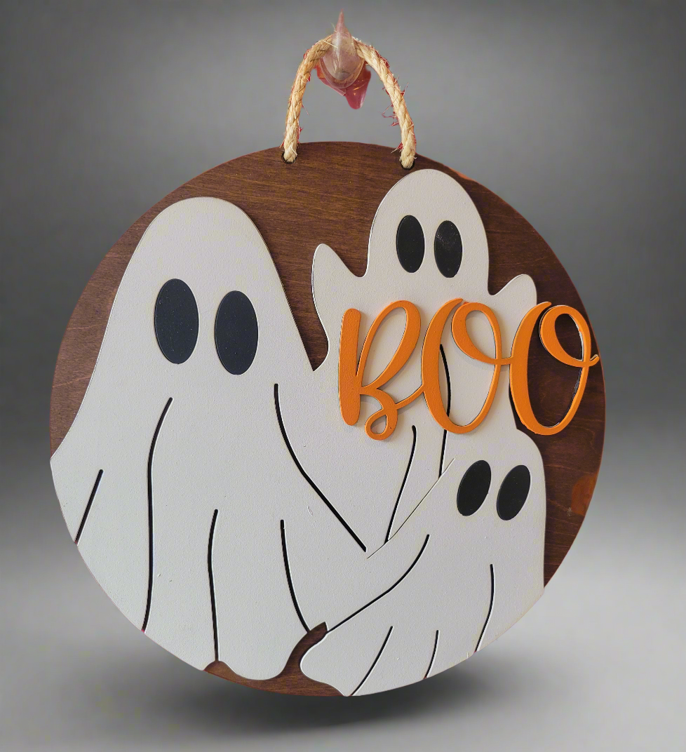 Round wooden Halloween wall sign featuring Boo lettering in natural wood finish for fall decorating