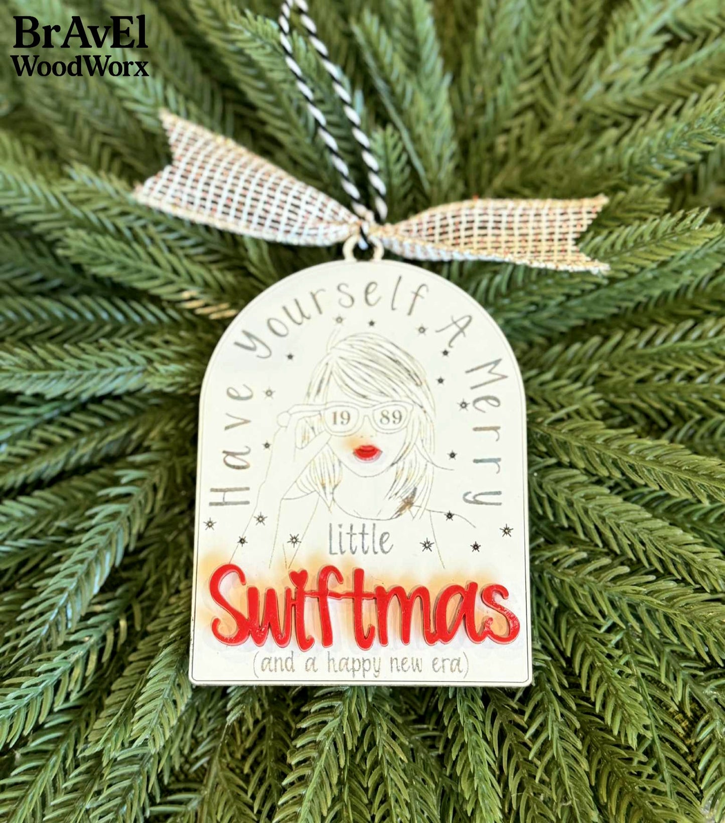 Decorative Christmas ornament with 'Little Swiftmas' text on a green tree