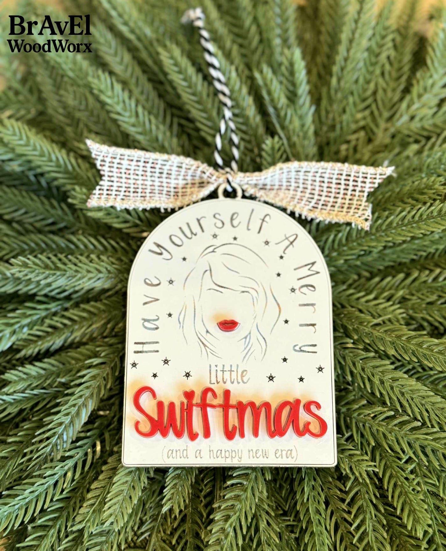 Decorative ornament with 'Have yourself a merry little Swiftmas' text on a Christmas tree, featuring BravEl WoodWorx branding.