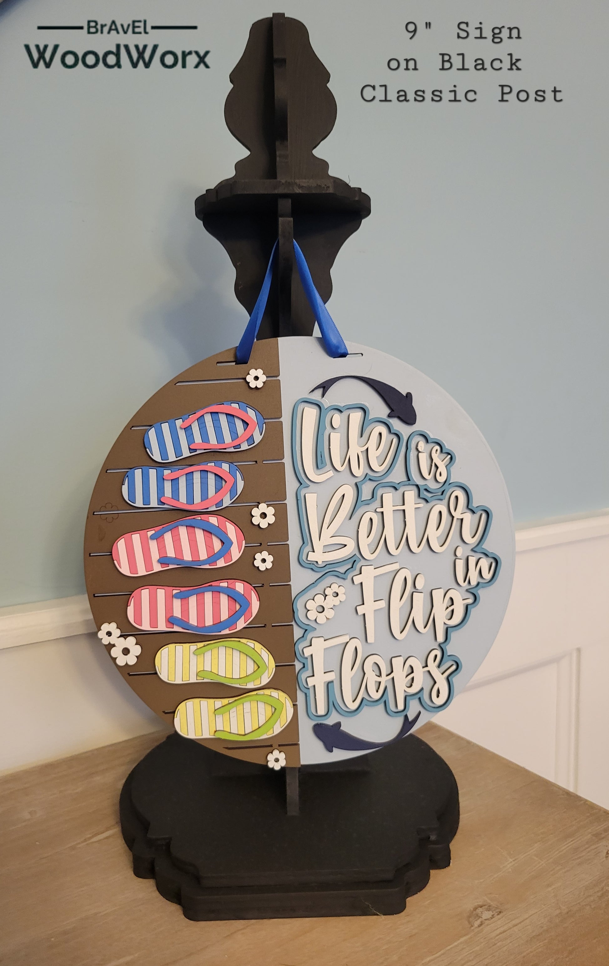 A rectangular wooden sign with a coastal vibe, featuring the text "Life is Better in Flip Flops" written in a playful, beach-inspired font. The background is painted in soft turquoise with a weathered wood texture, accented by illustrations of flip flops and small seashells. Perfect for beach houses, patios, or summer decor.black post