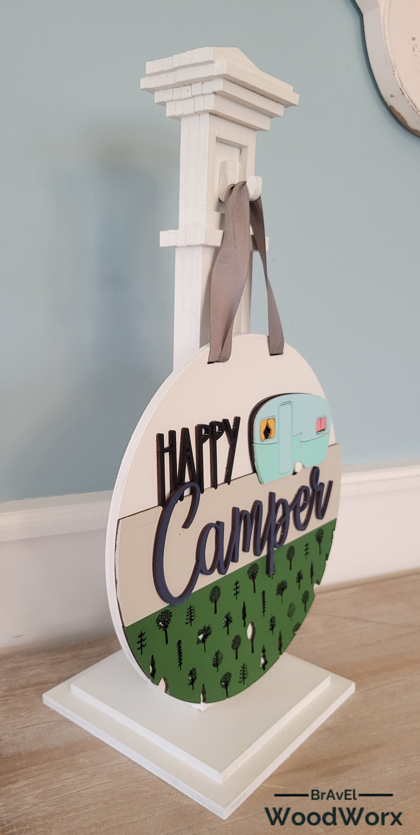 Handmade 'Happy Camper' wall door sign displayed on a post, featuring a charming rustic design with vibrant colors, a playful camper graphic, and personalized text. Perfect for adding a cozy, outdoor-inspired touch to any space. Post Side