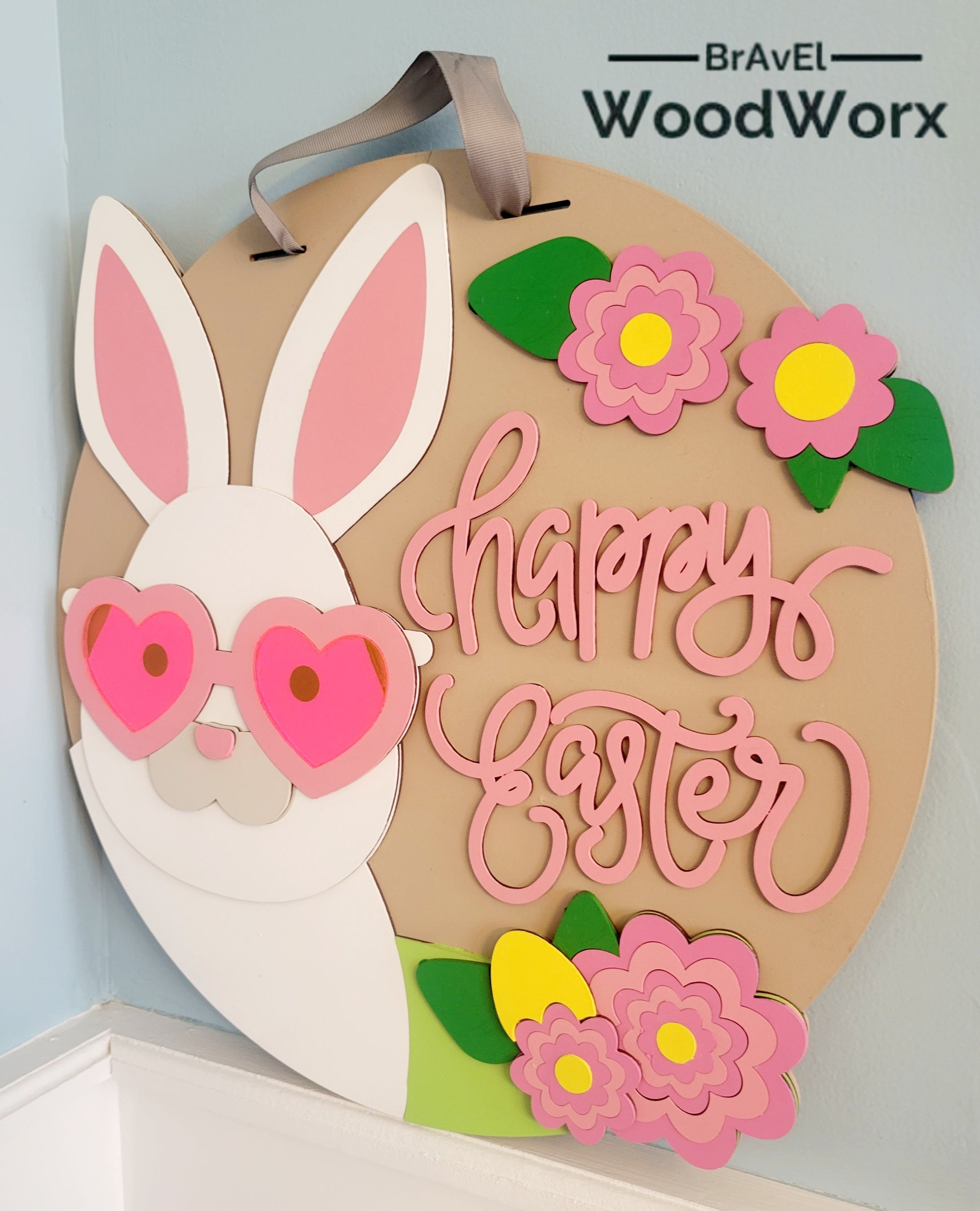 Happy Easter Bunny Door Hanger with Acrylic Sunglasses – Festive Spring Decor. Adorable wooden Easter bunny sign featuring stylish acrylic sunglasses, perfect for adding a fun and cheerful touch to your front door or home decor. Ideal for springtime decorations, Easter celebrations, and seasonal gifts. Handmade and high-quality, this cute bunny hanger enhances your holiday spirit. Great for indoor and outdoor use. Wall Mount