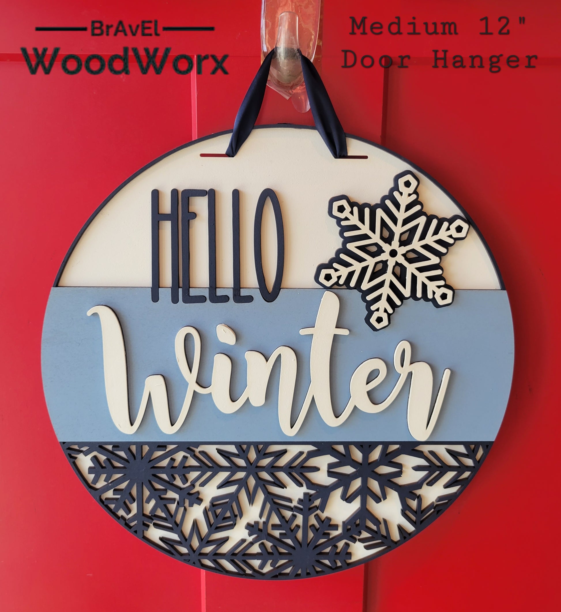 A round "Hello Winter" snowflake door hanger, crafted from wood, featuring intricate laser-cut snowflake designs and the text "Hello Winter" in elegant script. The sign is painted in a festive color palette, perfect for adding a seasonal touch to your home's decor. Hanging on a front door, it embodies warmth and winter charm 12 version