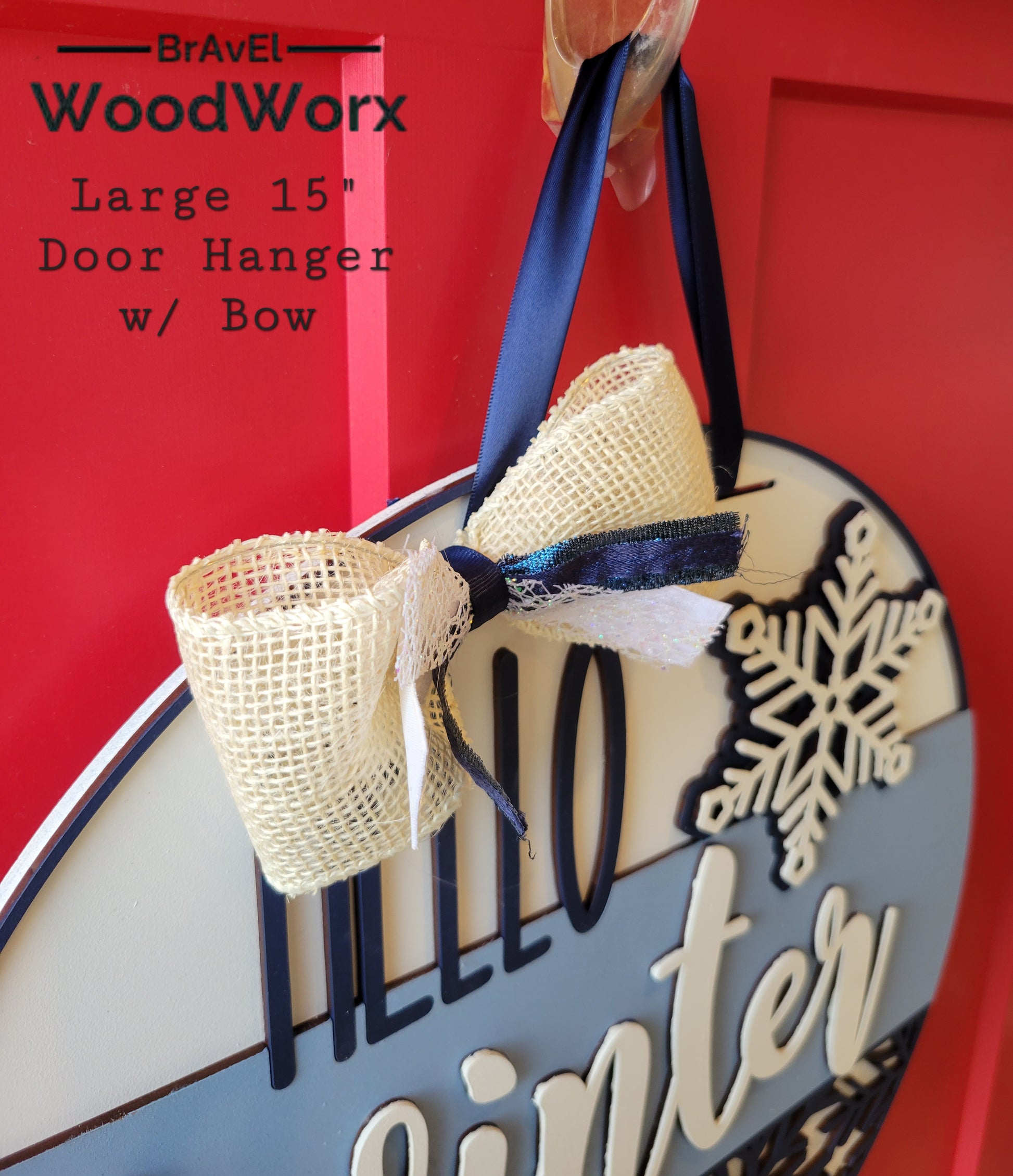 A round "Hello Winter" snowflake door hanger, crafted from wood, featuring intricate laser-cut snowflake designs and the text "Hello Winter" in elegant script. The sign is painted in a festive color palette, perfect for adding a seasonal touch to your home's decor. Hanging on a front door, it embodies warmth and winter charm Bow Close Up