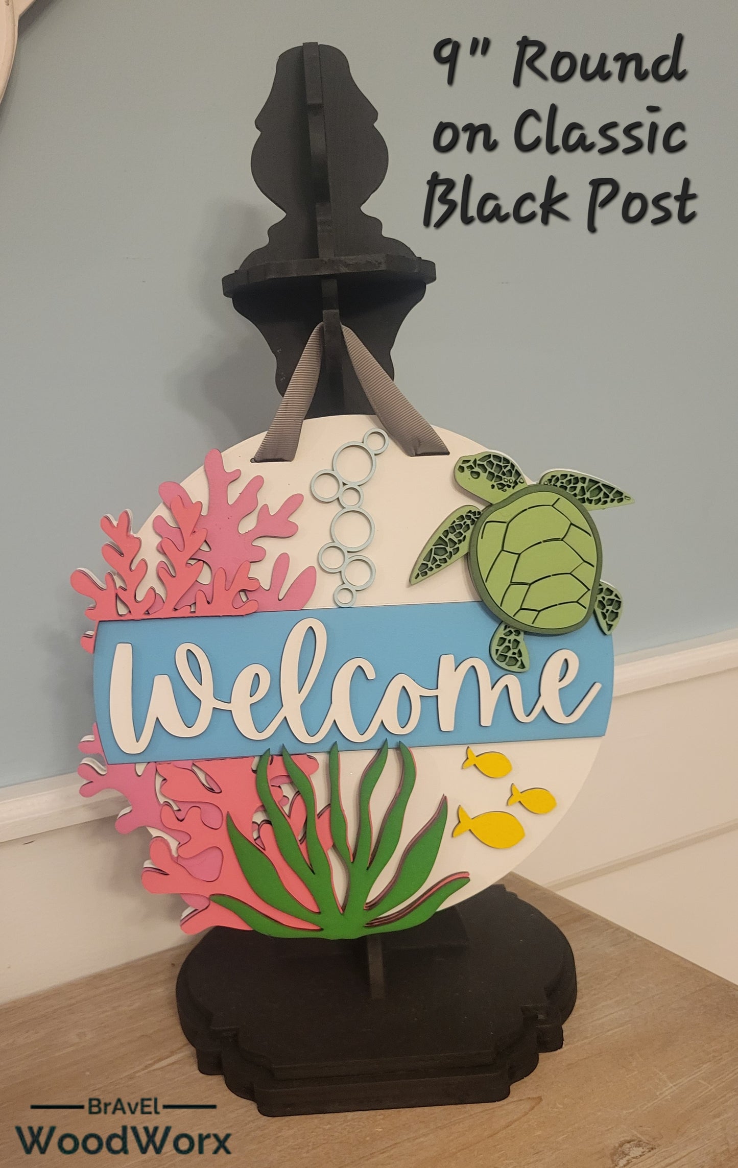 Welcome Sea Turtle Sign: A beautifully crafted wooden sign featuring a laser-engraved sea turtle design with the word 'Welcome' elegantly displayed. The sign has a coastal theme with soothing colors, perfect for beach houses, marine enthusiasts, or as a welcoming decorative piece for any space. Black Post