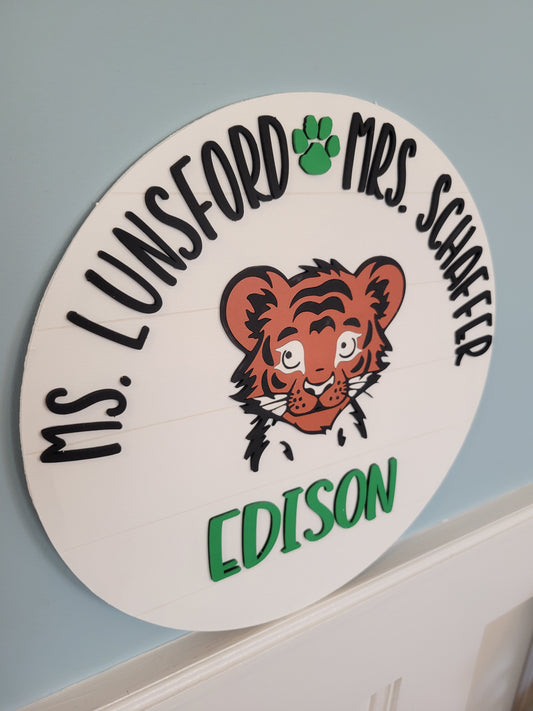 Circular nameplate with tiger illustration and text on a light blue background