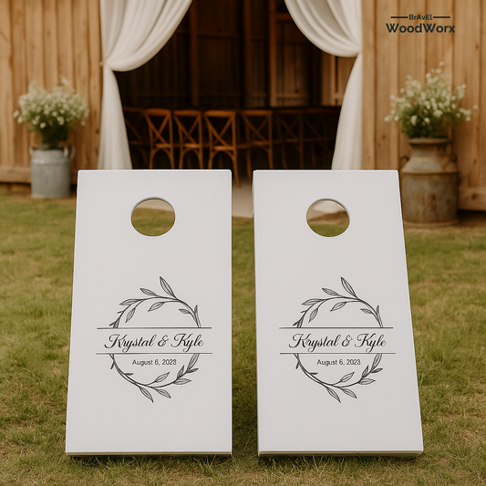 Two white cornhole boards with personalized design on grass, with 'WoodWorx' branding.