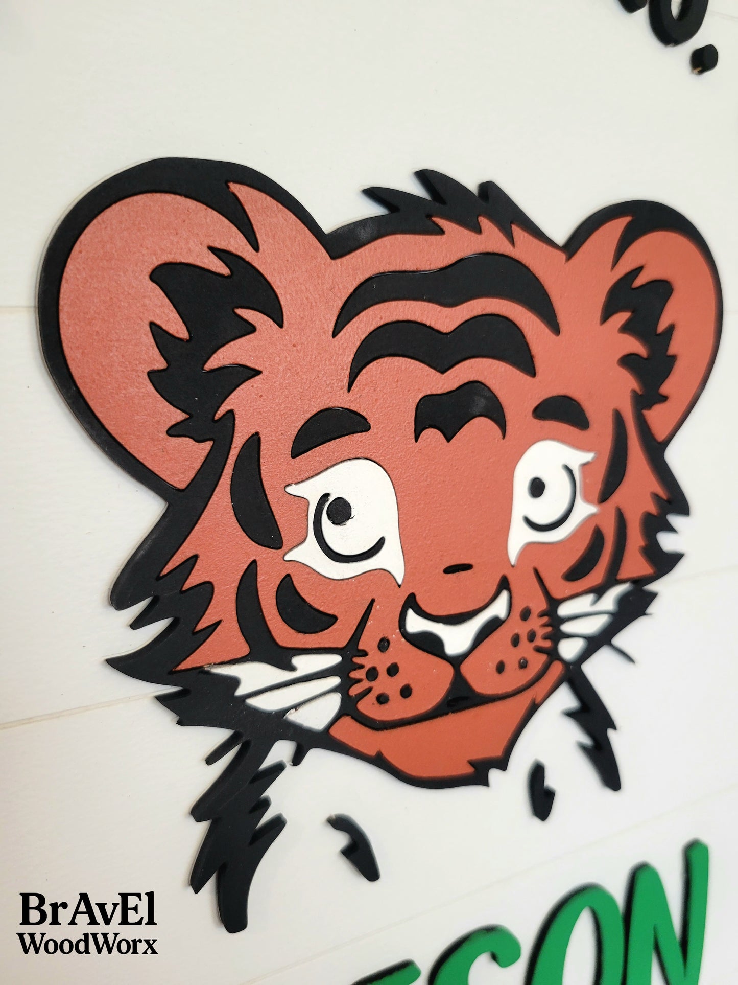 Stylized tiger head design on a white background with 'BravEl WoodWorx' branding.