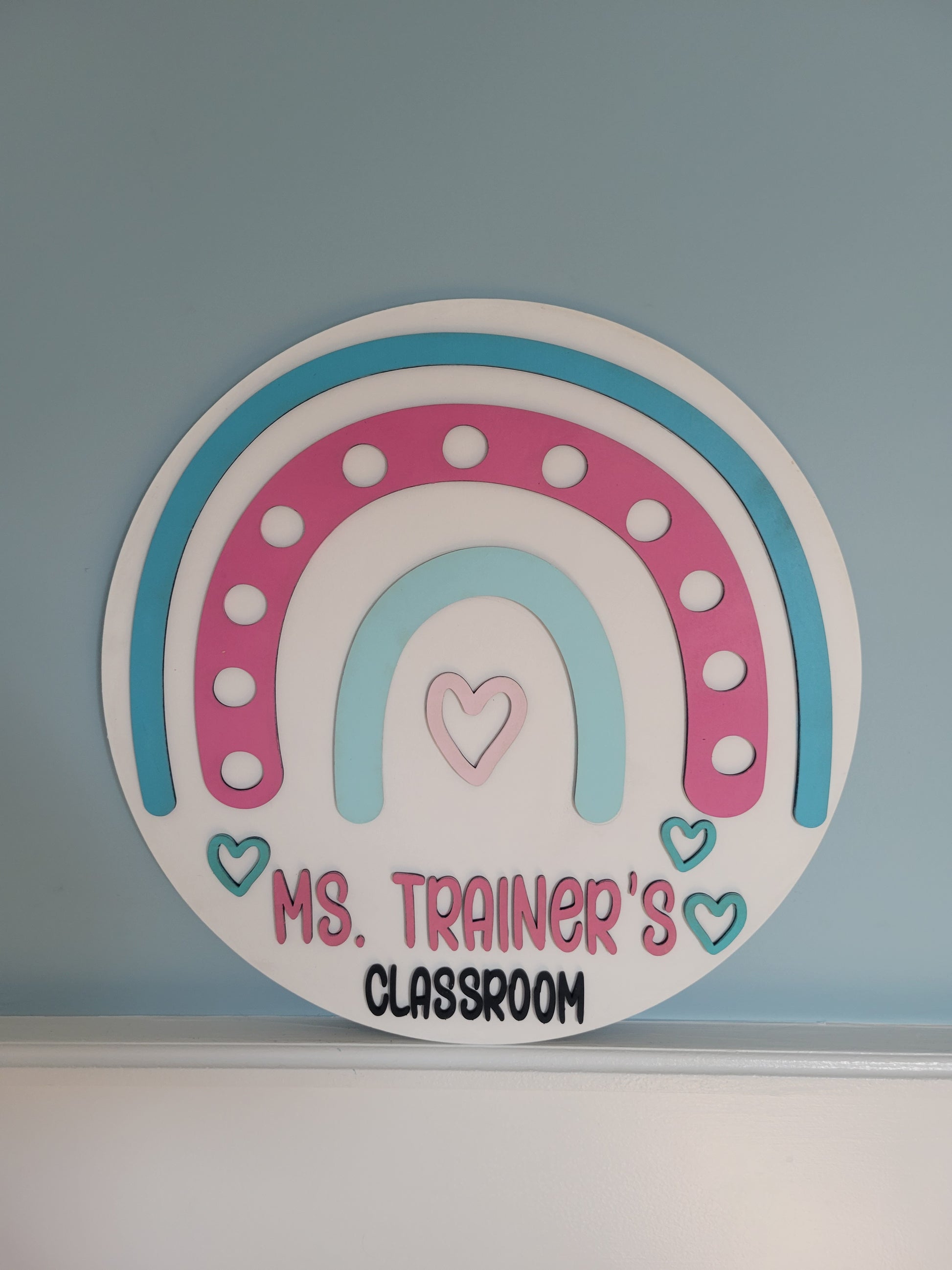 Decorative sticker with a rainbow design and text on a blue wall