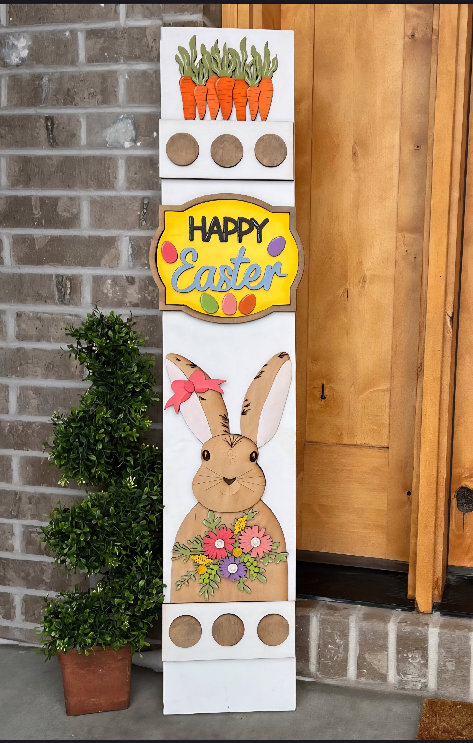 Decorative Easter sign with a bunny and carrots on a brick wall background