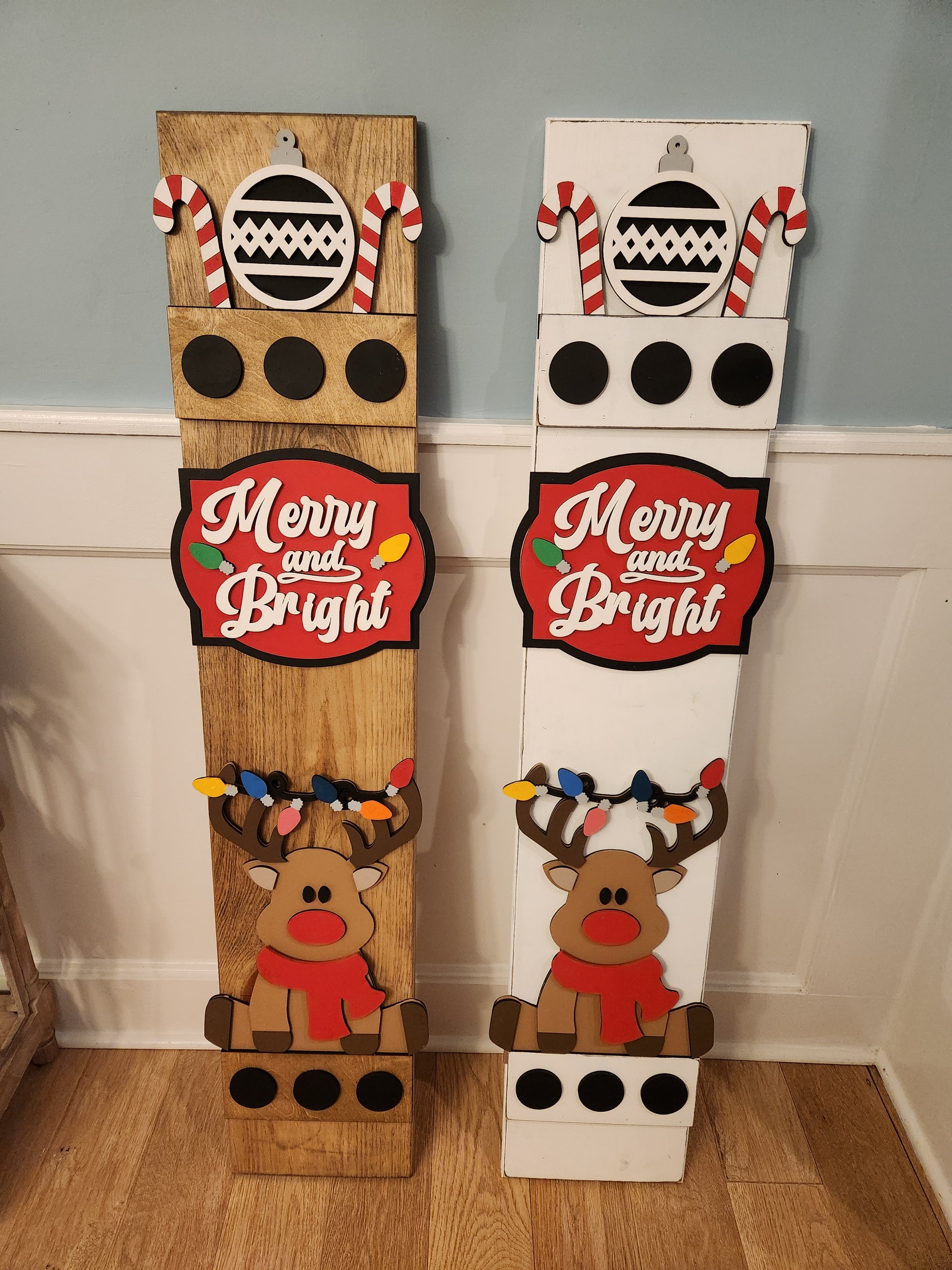 Decorative Christmas door mat with reindeer and candy cane design on a wooden floor.