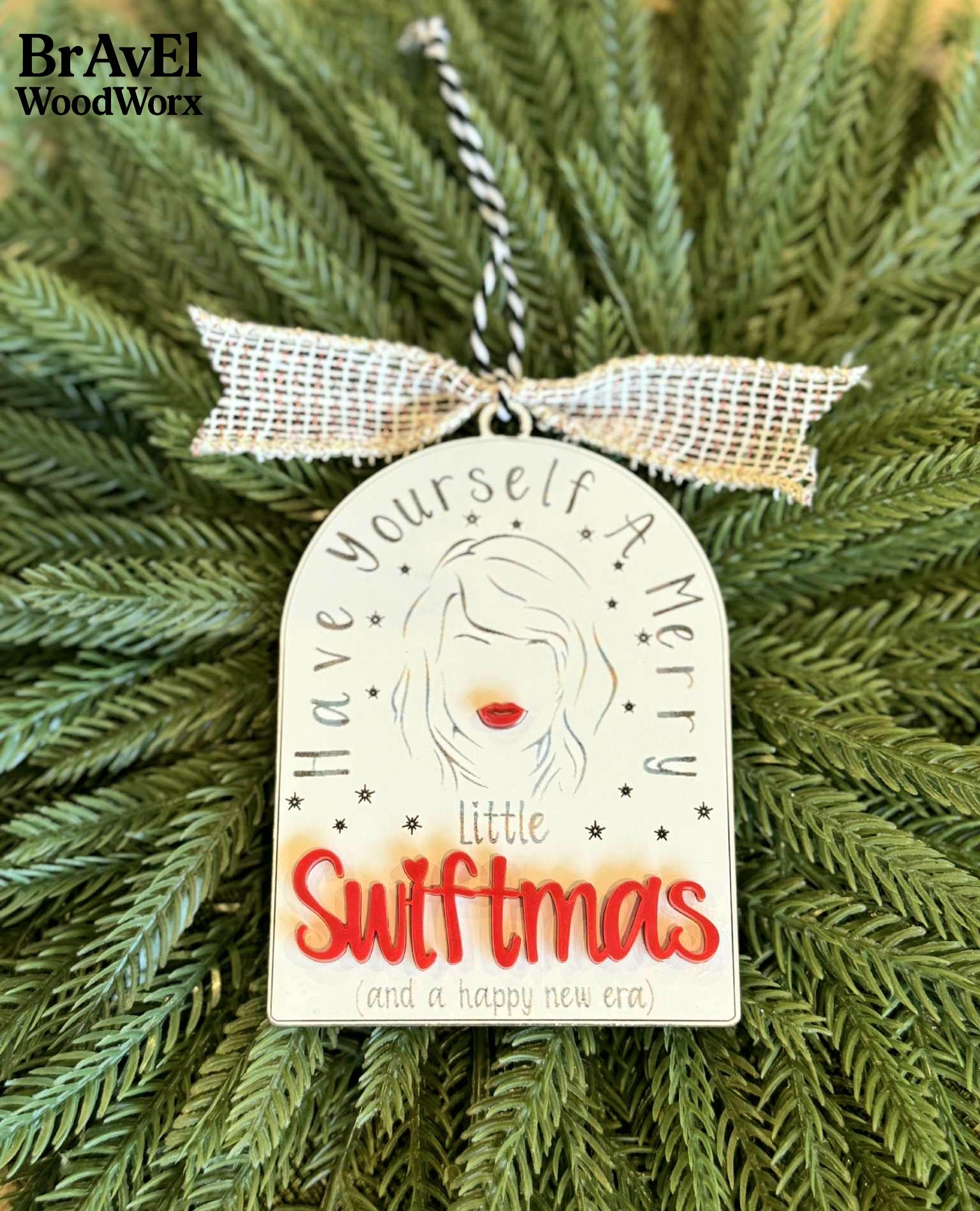 Decorative ornament with 'Have yourself a merry little Swiftmas' text on a Christmas tree, featuring BravEl WoodWorx branding.